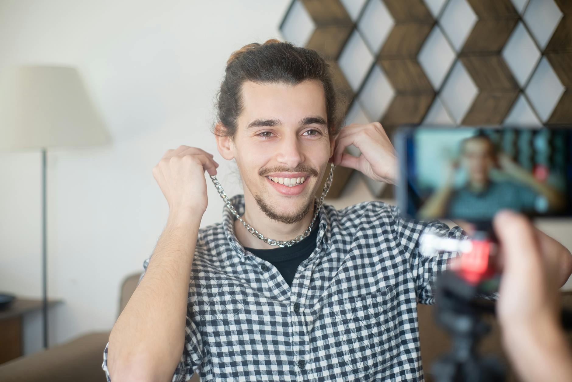 a man on camera holding decorative chains